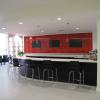 Create the most inviting social space / meeting spot in High Point.  If a salesman is not available, rather than waiting impatiently in a murky lobby, customers are treated to an upscale coffee/entertainment bar.